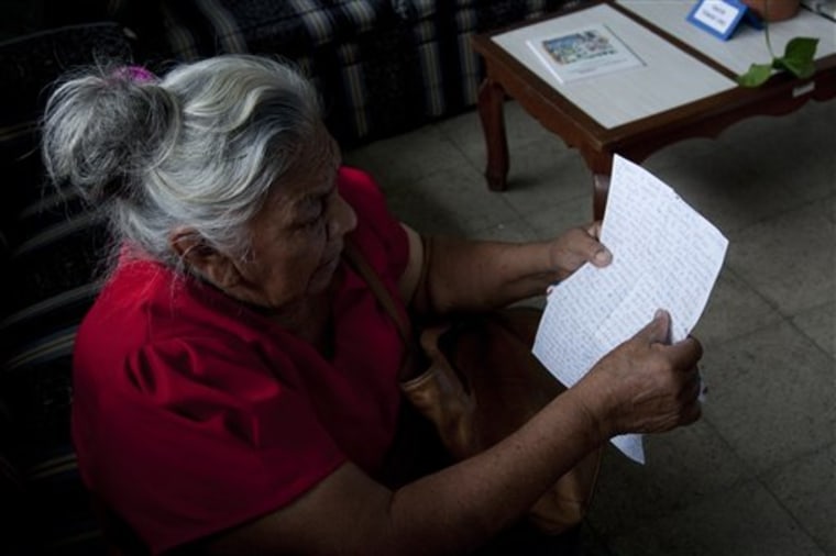Paula Cruz Martinez, 77, looks at the last letter she received from her son, who she did not name for security reasons, as she visits the Foreign Ministry in search of her son's whereabouts in San Salvador, El Salvador Monday. Martinez said her son, who traveled through Mexico to reach the U.S., might be among the 72 migrants who were killed by an alleged drug gang in northern Mexico.